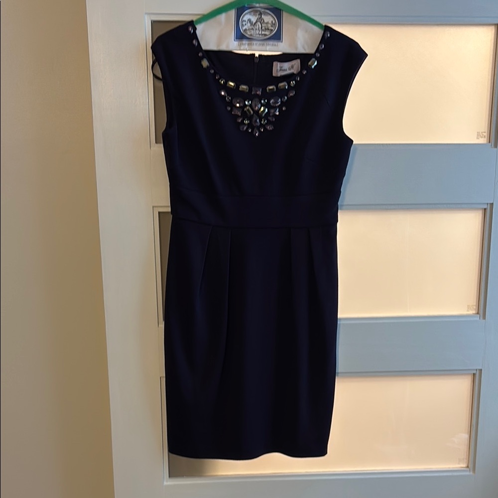 Elegant purple dress with embellished neckline. Zips up back.